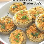 A white bowl filled with stuffed artichoke bottoms.