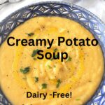 A blue dish filled with a creamy thick potato soup with some parsley on top.