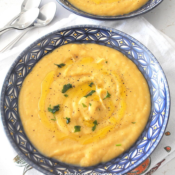 A blue bowl filled with creamy potato soup.