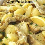 A sheet pan filled with roasted artichoke bottoms and potatoes sliced.