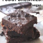 Three flourless brownies piled on top of one another.