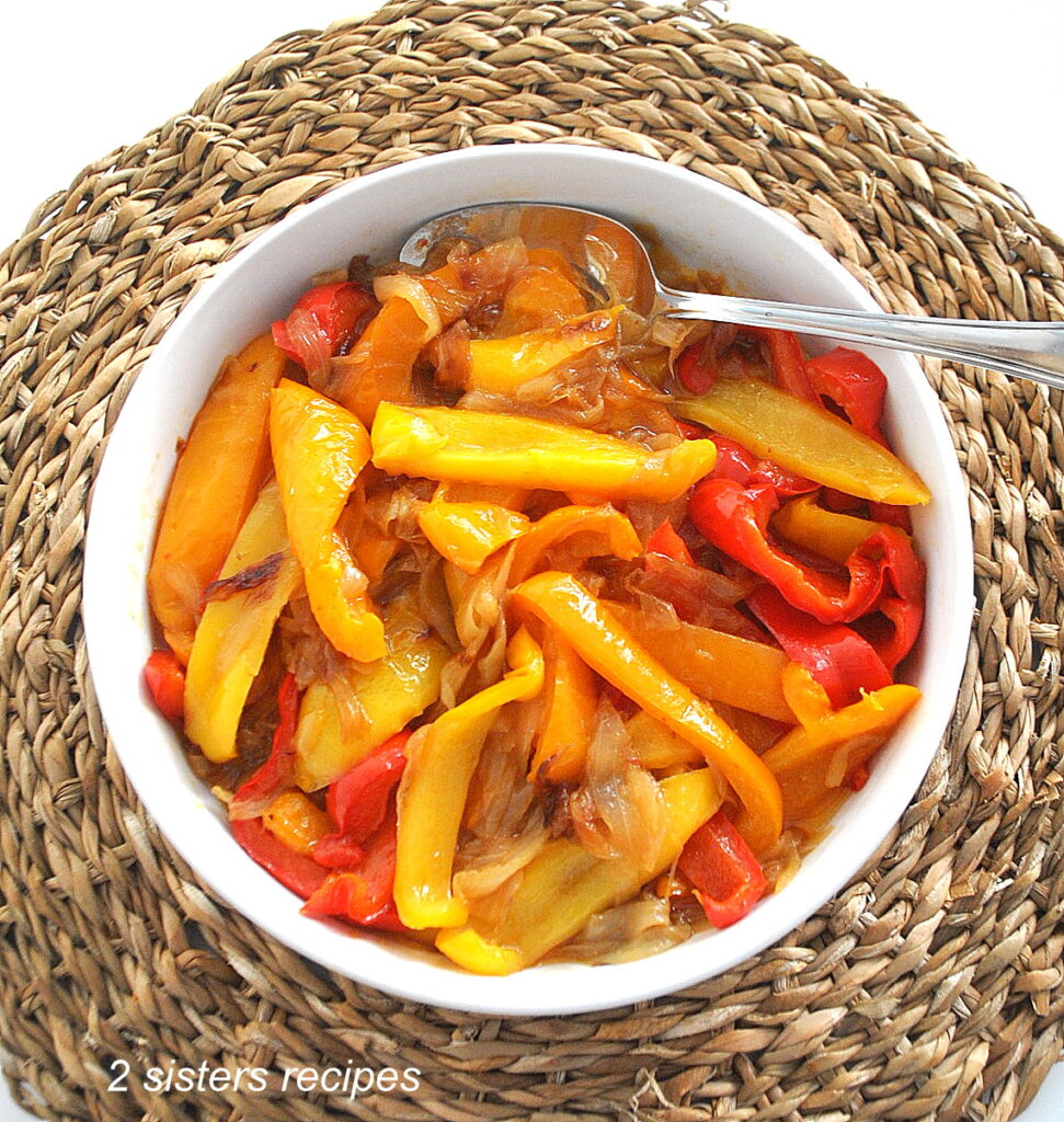 white platter with sautéed peppers and onions..