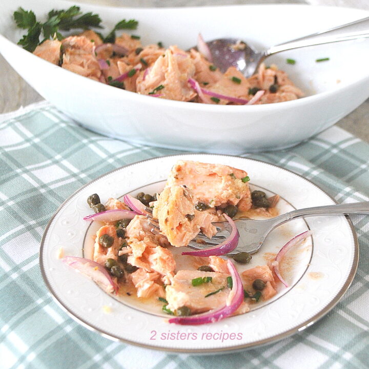A small plate with a serving of salmon salad with a forkful.