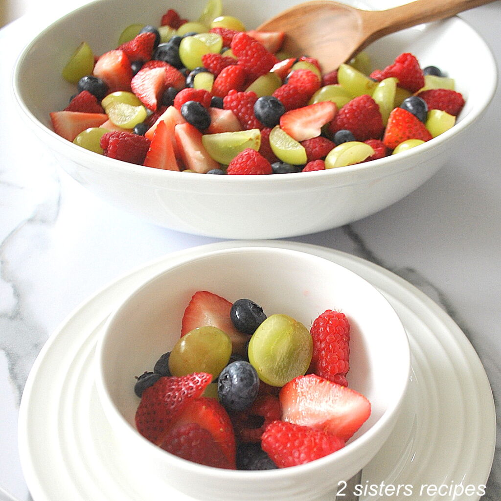 A small serving bowl filled with mixed berries. 