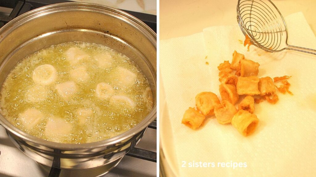 Frying up calamari in a pot with oil. Draining them on paper towels.