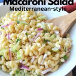A bowl filled with elbow pasta salad with chopped red onions and celery.