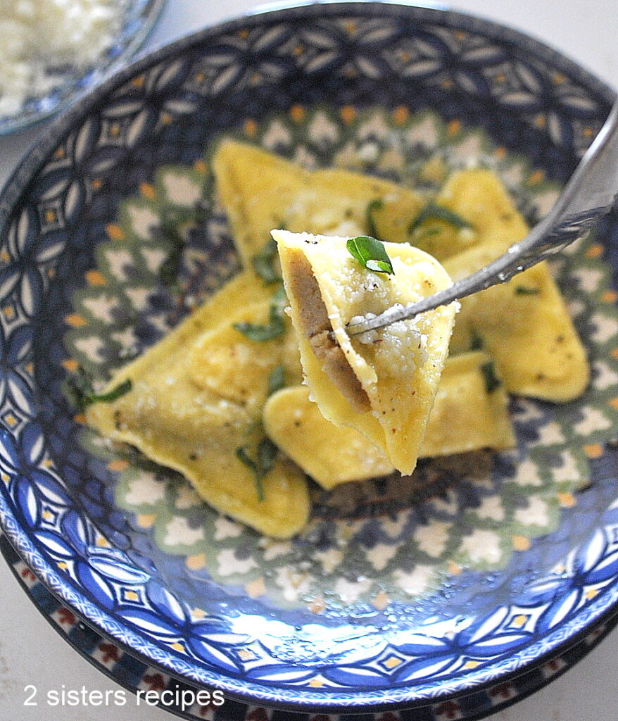 A forkful of ravioli stuffed with porcini mushroom & truffle. 