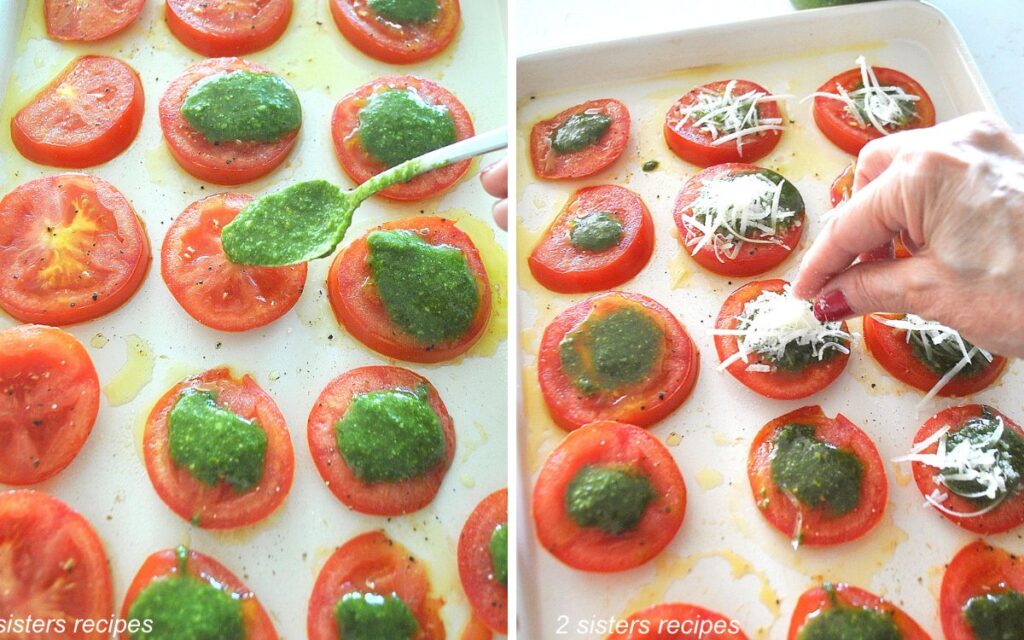 A sheet pan filled with sliced tomatoes with spooning pesto sauce and grated cheese. 