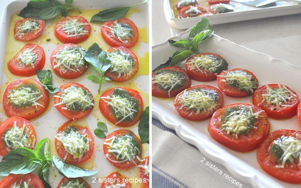 A white sheet pan filled with baked sliced tomatoes topped with pesto and cheese. 