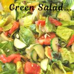 A yellow salad bowl filled with lettuce, chopped tomatoes, cucumbers, and red onions.