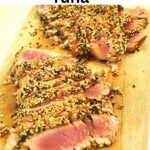 A cutting board with sliced sesame-crusted tuna.