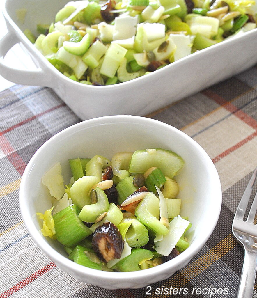 A small bowl of celery salad with a fork beside it. 